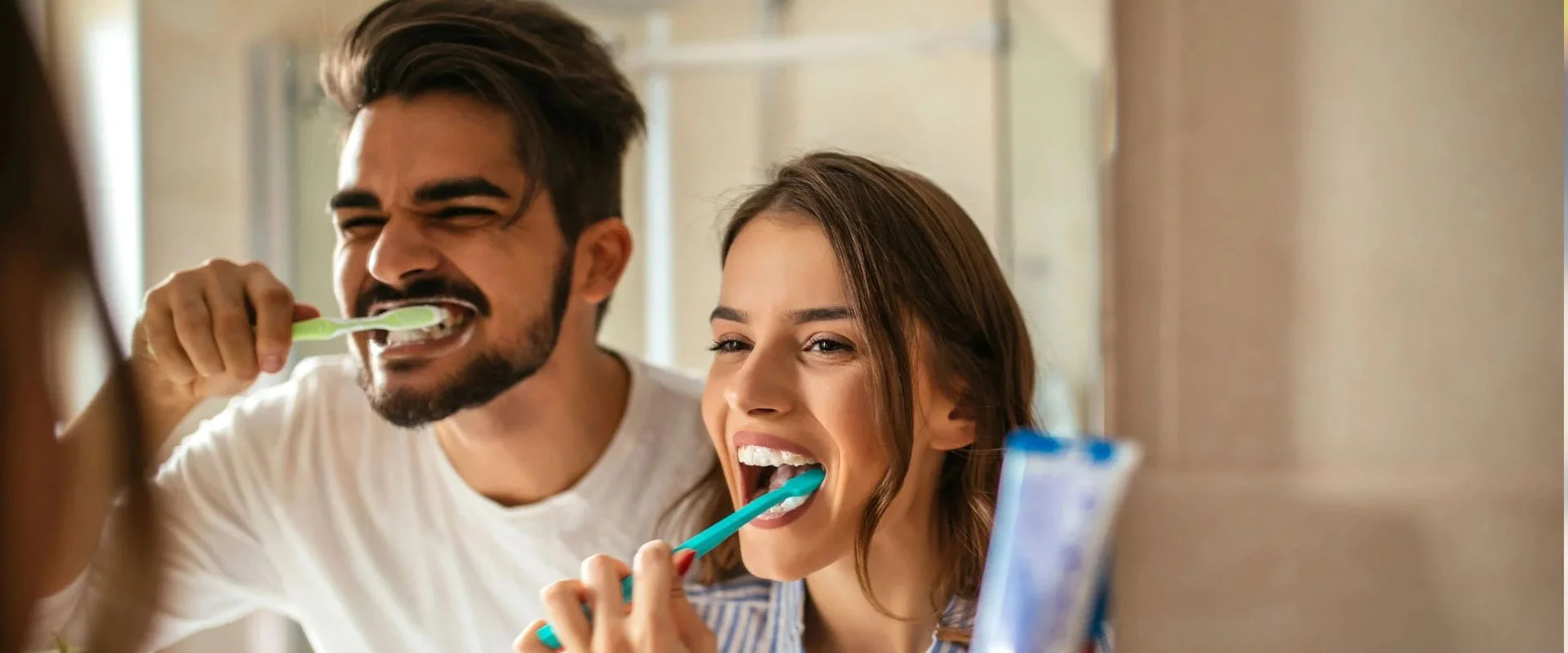 Couple brushing their teeth together