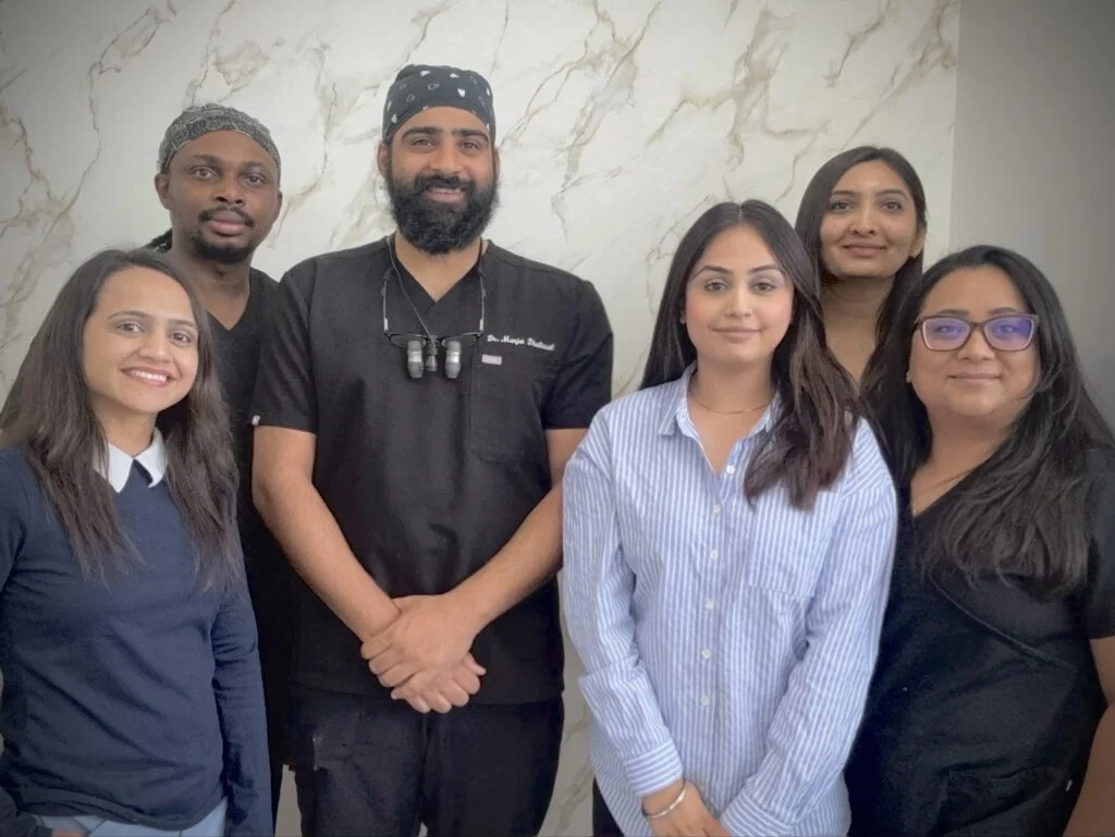 Woodbend Dental team members standing together in the clinic